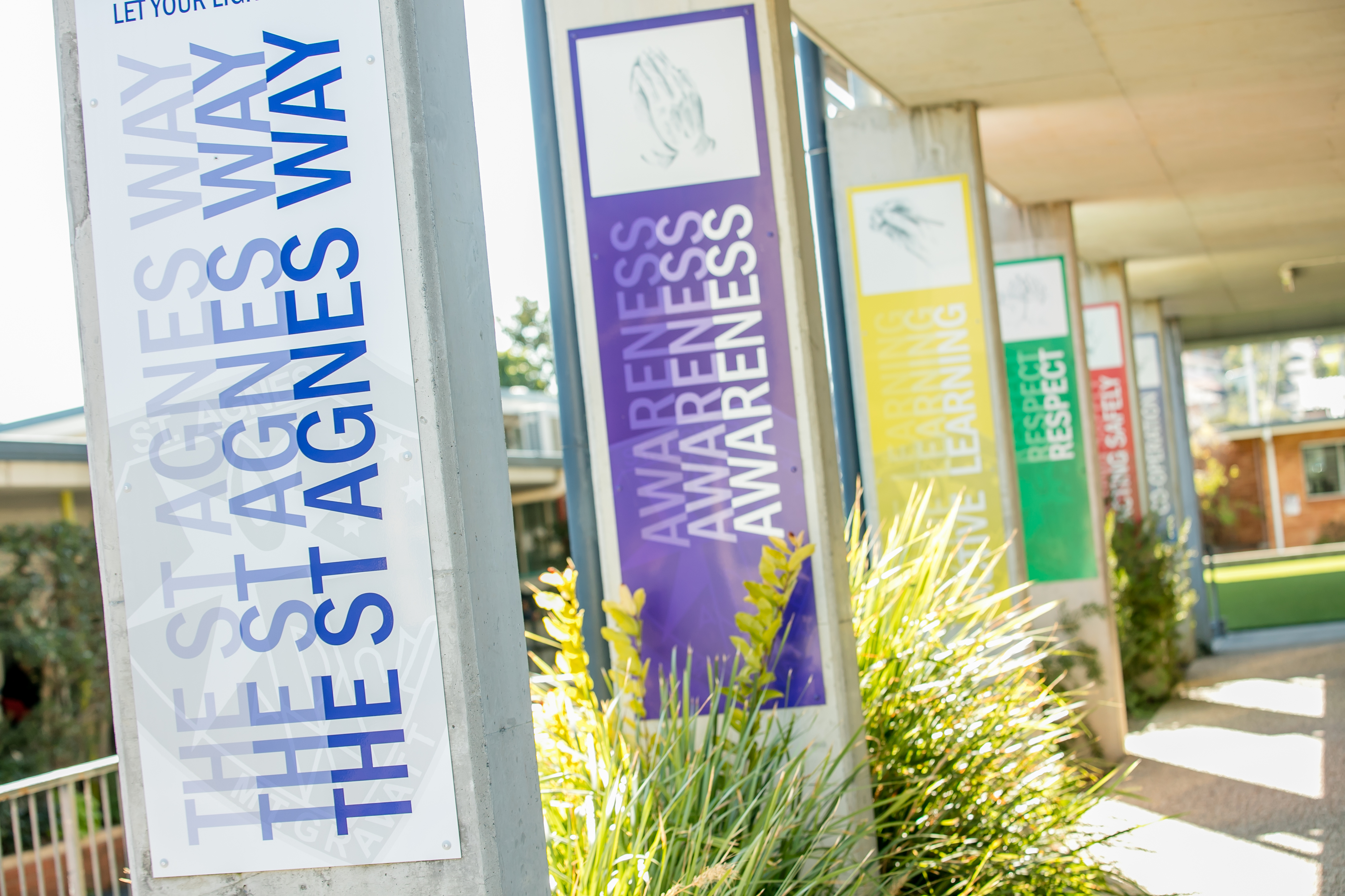 School walkway signs showing the Agnes Way values.